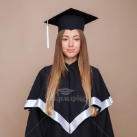Black matte graduation gown with cap and tassel on it