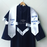 Black matte graduation gown with cap and tassel on it